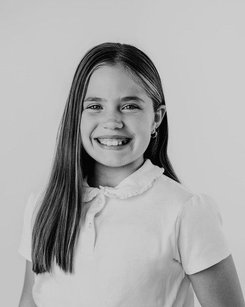 black and white school portrait of a girl in a white collared polo, Denver