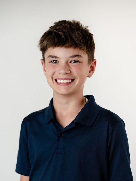 school portrait of a boy in a navy polo, Denver Colorado