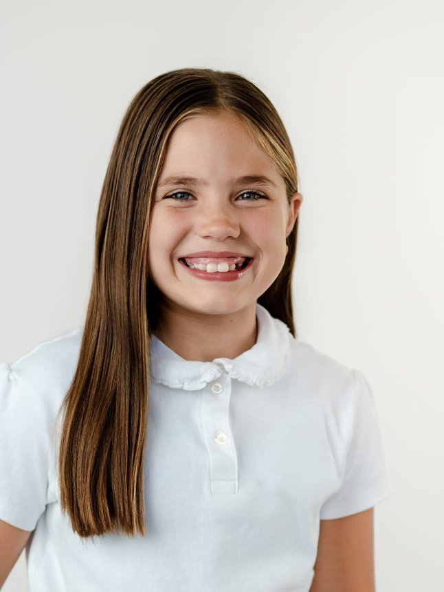 school portrait of a girl in a white collared polo, Denver Colorado