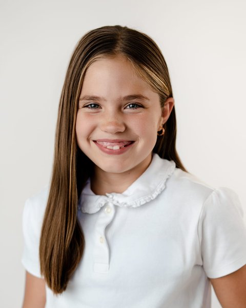 school picture day portrait of a girl in a white collared polo, Denver Colorado